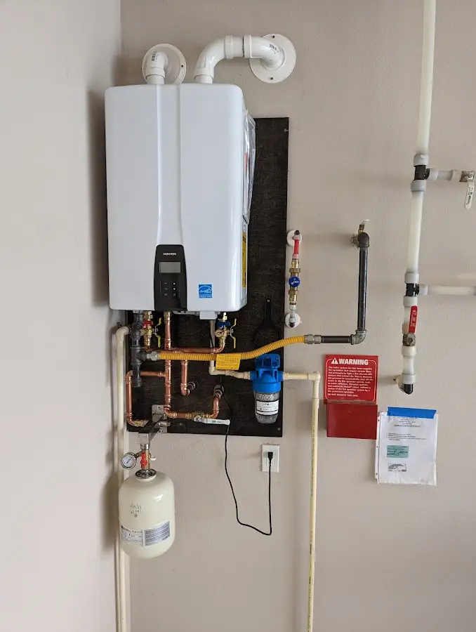 Professional plumber installing copper piping in a Thomson home